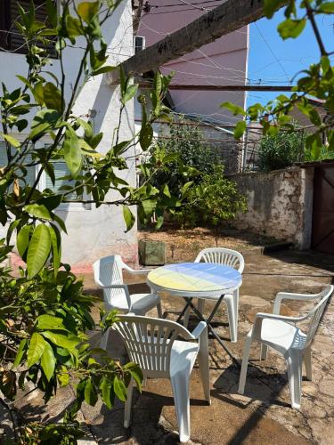 a patio with a table and chairs and a table at Bajatova Heritage House with Private Courtyard in Mostar