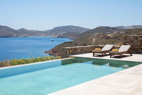 a swimming pool with a view of the ocean at Villa Sozon Mykonos in Agios Sostis Mykonos