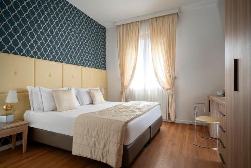 a bedroom with a large bed and a window at Re Enzo in Bologna