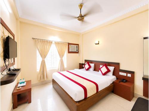 a bedroom with a large bed and a television at The Annapurna Resort Hotel & Restaurant - Walking From 100m From Sea Beach, Free Wifi, Parking Available ! Luxury & Best Hotel in Puri in Puri