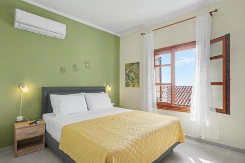 a bedroom with a bed and a window with a view at Kallichoron 3 fortezza Kavala in Kavála