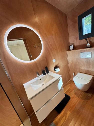 a bathroom with a sink and a mirror and a toilet at N&L Signature - Ô Lodge in Mornas