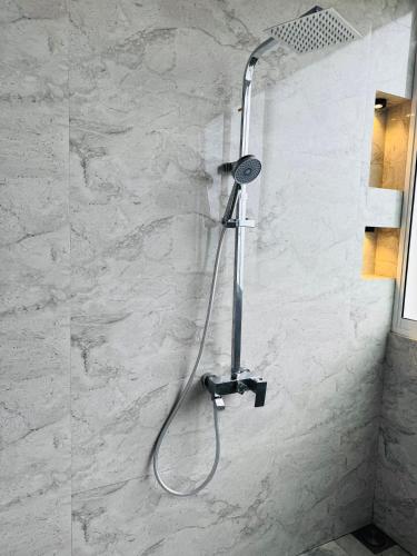 a shower with a shower head in a bathroom at Rainforest mountain resort in Deniyaya