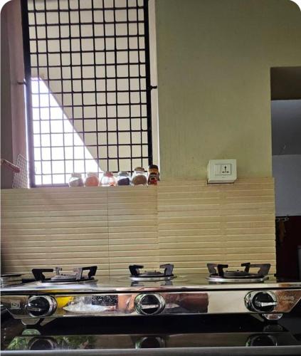 a stove top in a kitchen with a counter at Marwa in Kannur