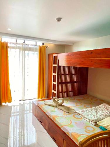a bedroom with a wooden bunk bed with a ladder at Unit 8F-34 Megatower Residences 3 in Baguio