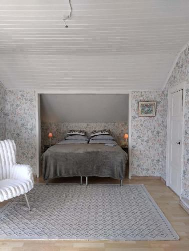 a bedroom with a bed and a white ceiling at Heritage House at Villa Sofia in Lahti