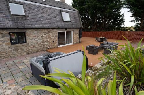 a tv sitting in the yard of a house at Woodside Barn in Newmacher
