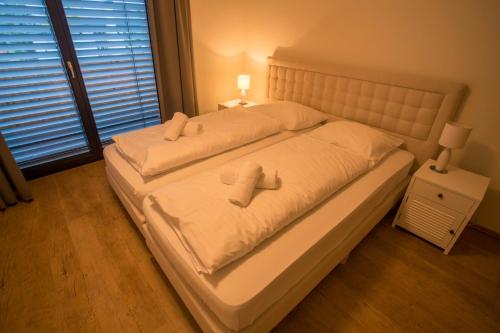 a bedroom with a bed with two pillows on it at Appart Gastauer in Sankt Gallenkirch