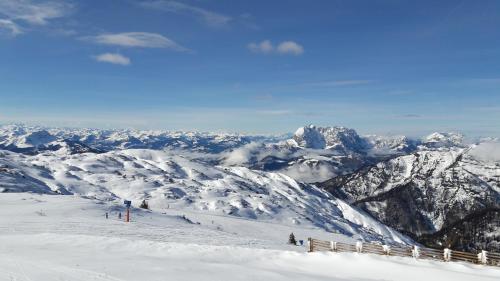 a snow covered mountain with people on a ski slope at Familie Seiwald in Waidring