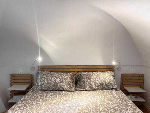a bedroom with a bed with two pillows at Tenuta Moffa in Tramonti