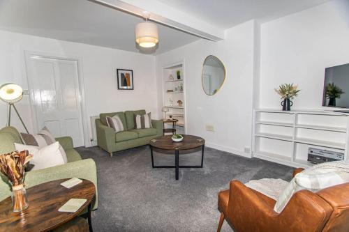 a living room with a couch and a table at Beach House in Thurso