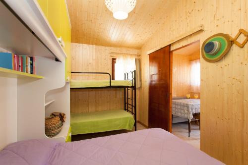 a bedroom with bunk beds in a small room at Ca' Berton Village in Cavallino-Treporti