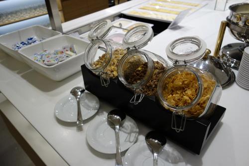 a buffet with silver dishes and spoons on a counter at Hotel Urs und Viktor in Bettlach