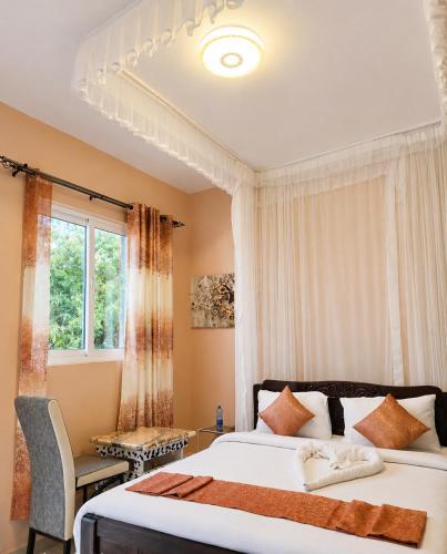 a bedroom with two beds and a window at Lesha Park Hotel in Libwezi