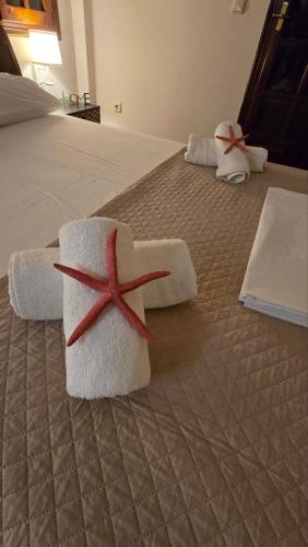 a bed with two towels with a starfish on it at Villa ChrysPa Attica in Dhílesi