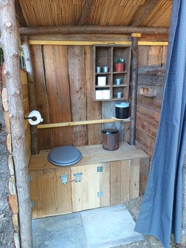 a wooden out house with a toilet in it at Le nid de bois insolite in Haget