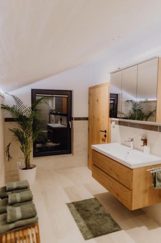 a bathroom with a sink and a large mirror at Chalet im Obstgarten in Lengau
