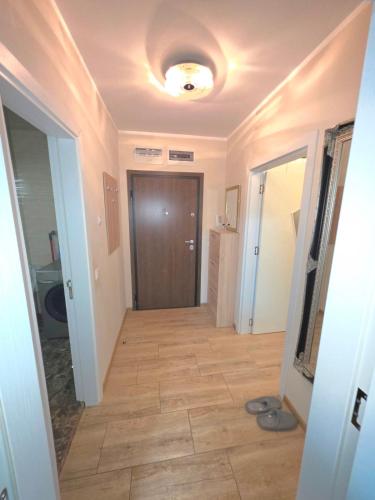 a hallway with a door and a tile floor at Mountain View Apartment in Sofia