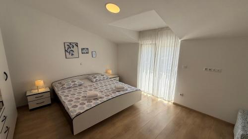 a bedroom with a bed and a large window at Private Villa Bonaventura with Pool & Jacuzzi & BBQ for Families & Groups near Split in Donja Mala