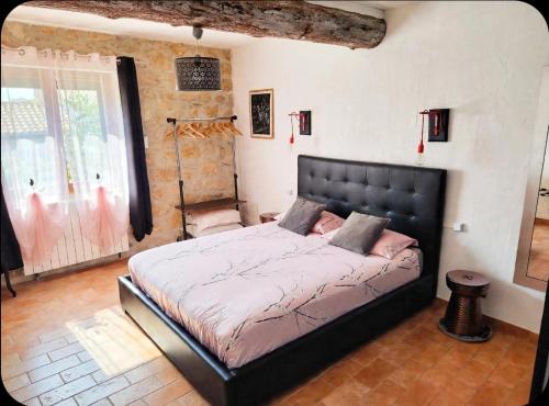 a bedroom with a large bed in a room at VILLA ARTEMIA - chambre d hôtes labellisée massages-piscine-climatisation in Sigean