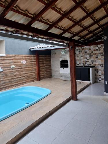 a large swimming pool in a room with a patio at Unamar Beach in Cabo Frio