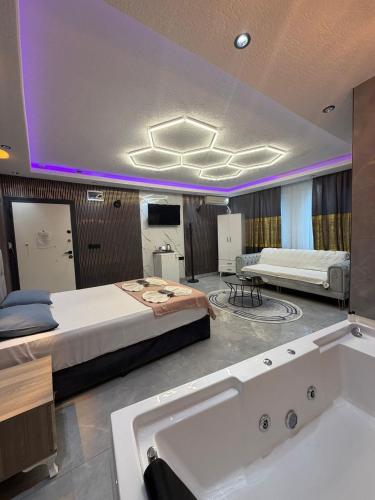 a bedroom with two beds and a bath tub at KRAL GRAND OTEl in Istanbul