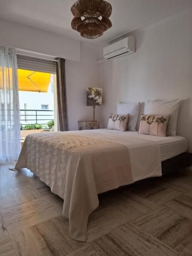 a bedroom with a large bed with a large window at Cannes à Pied in Cannes