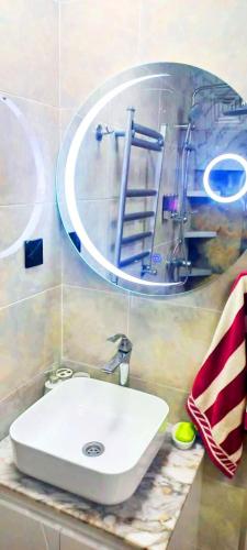 a bathroom with a white sink and a mirror at U seymura qecres in Qǝçrǝş