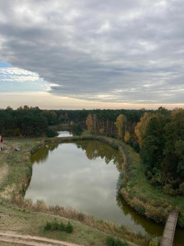 an aerial view of a river with trees in the background at Ostrowo Młyn in Wągrowiec