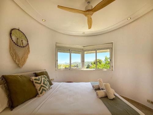 a bedroom with a large bed with a ceiling at Villa Claudia by Hello Homes Sitges in Sitges