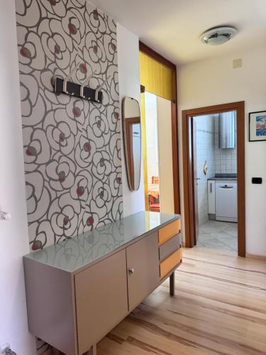 a bathroom with a dresser and a mirror on a wall at Appartement Vista Lago in Riva del Garda