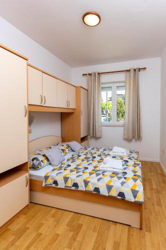 a bedroom with a bed and a window at Marin in Lopar