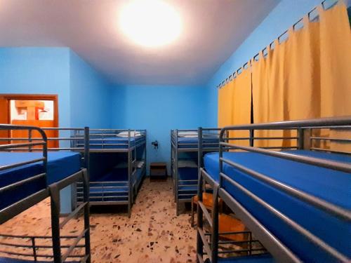 a room with blue walls and blue bunk beds at Rifugio lo Schioppo in Morino