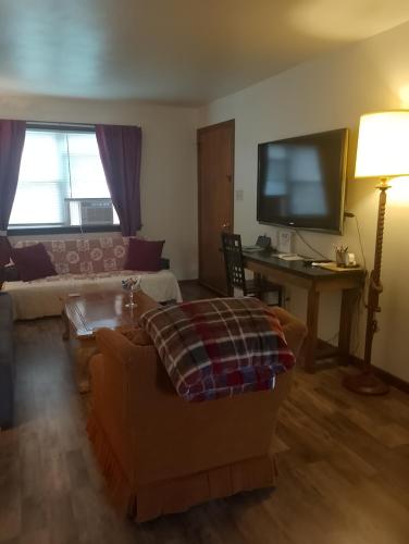 a living room with a couch and a flat screen tv at Simple Stay in Youngstown