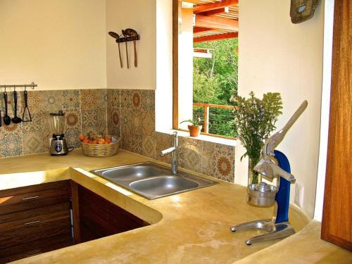 a kitchen counter with a sink and a window at Casa Monte Pacífico, jacuzzi, wifi Starlink y vista al mar in San Agustinillo