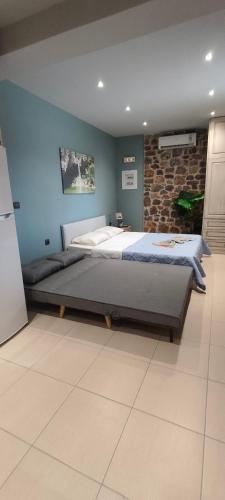 a large bed in a bedroom with a blue wall at Villa Sotiriou in Límni
