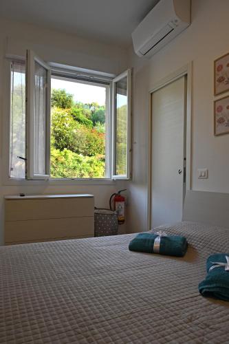 a bedroom with a bed with a large window at Casa Lissi in Bordighera