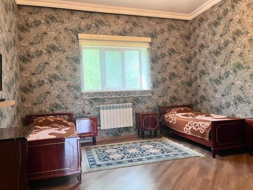 a bedroom with two beds and a window at Halal House Vip in Qusar