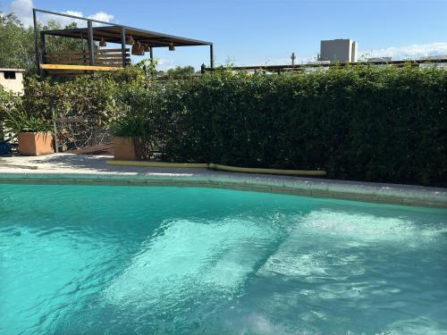 a large pool of blue water in a yard at Vivaldi Suites in Villa Carlos Paz