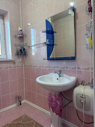 a bathroom with a sink and a mirror at Ayara home in Kyzart