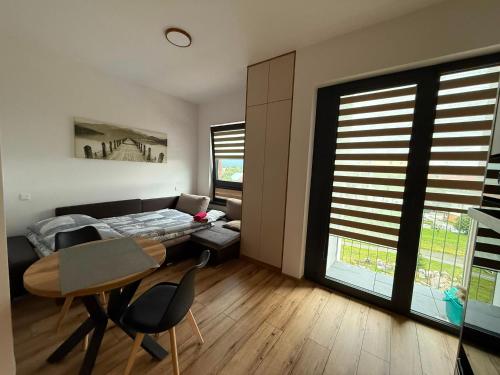a bedroom with a bed and a table and chairs at Apartmán 504 Svit in Jezersko