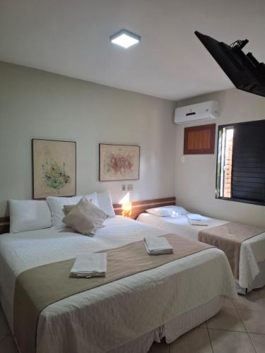 a bedroom with two large beds in a room at Alpes Hotel in Venda Nova do Imigrante