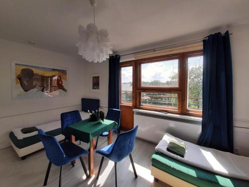 a room with a table and chairs and a bed at WILLA HONO LULU in Busko-Zdrój