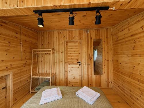 a log cabin with a bed and a ladder in it at Chalet Hatsvali - Ushba Viewpoint Rooms & Café in Mestia