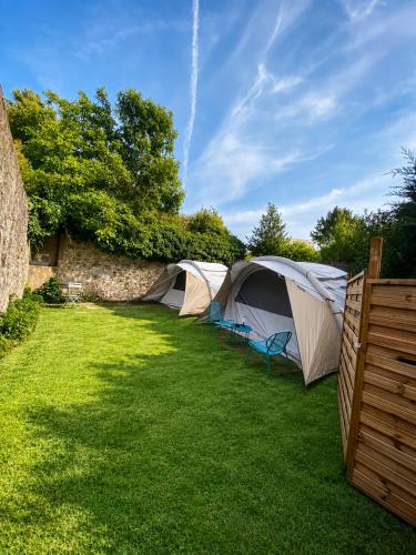 a group of tents in a grassy yard at Glamping - accès JACUZZI et SAUNA in Boulogne-sur-Mer