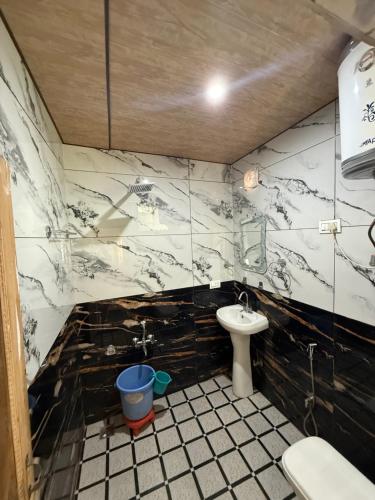 a bathroom with a sink and a toilet at Lakes and peaks in Srinagar