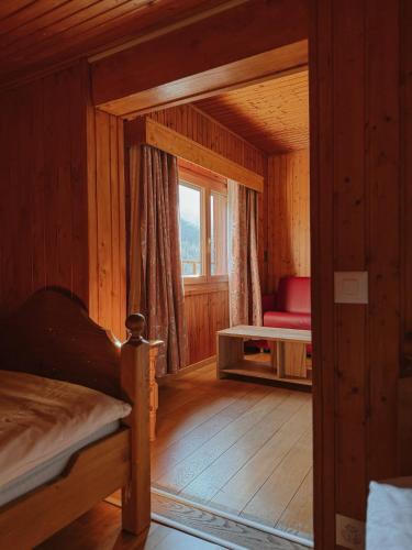 a small room with a bed and a window at Le Refuge Hotel Restaurant in Ayer