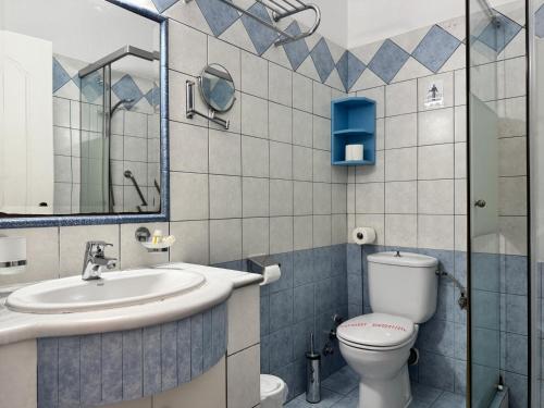 a bathroom with a toilet and a sink at Aegean Sun Hotel in Skala Rachoniou