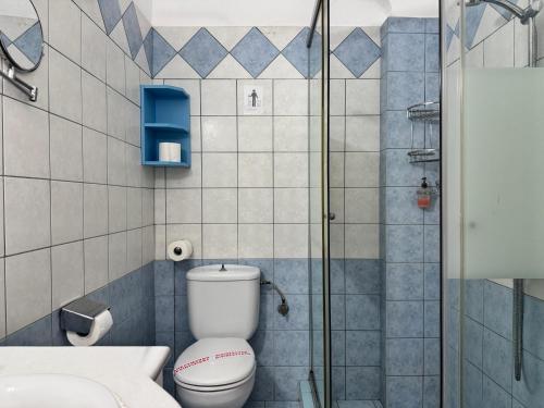a bathroom with a toilet and a glass shower at Aegean Sun Hotel in Skala Rachoniou