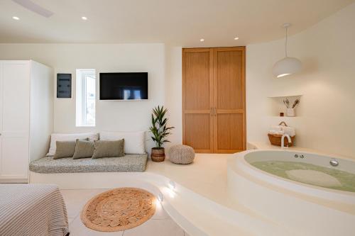 a bathroom with a large tub in a room at Naxia Gaia Suites in Agia Anna Naxos